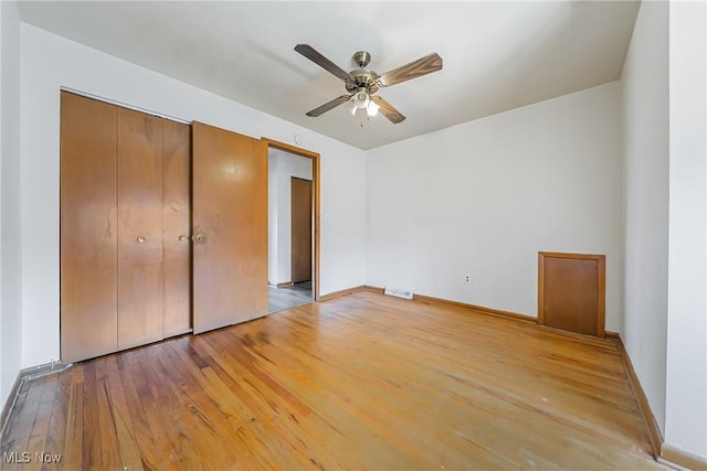 27701 Mills Ave Unit 2N, Euclid, OH 44132 - unfurnished bedroom featuring wood finished floors, a closet, baseboards, and a ceiling fan