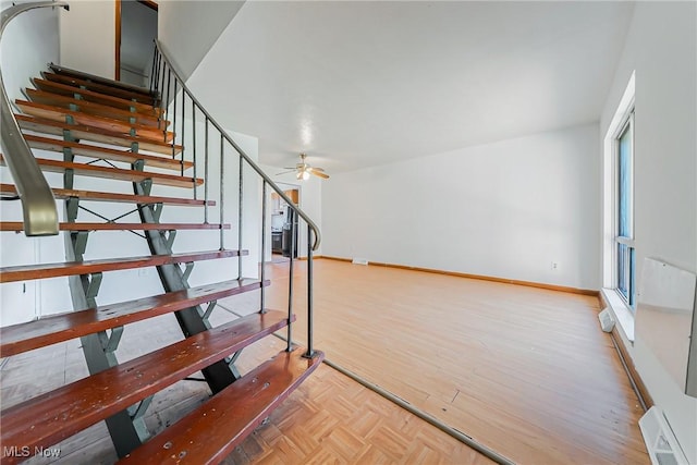 27701 Mills Ave Unit 2N, Euclid, OH 44132 - staircase featuring ceiling fan, baseboards, and parquet flooring