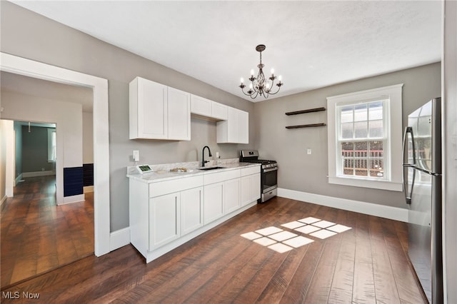 6813 W Clinton Ave, Cleveland, OH 44102 - kitchen with appliances with stainless steel finishes, a sink, baseboards, light countertops, and white cabinets