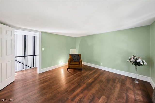 6813 W Clinton Ave, Cleveland, OH 44102 - unfurnished room featuring baseboards, wood finished floors, and an upstairs landing