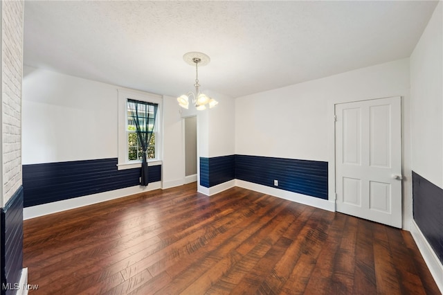 6813 W Clinton Ave, Cleveland, OH 44102 - spare room featuring a chandelier, baseboards, and wood finished floors