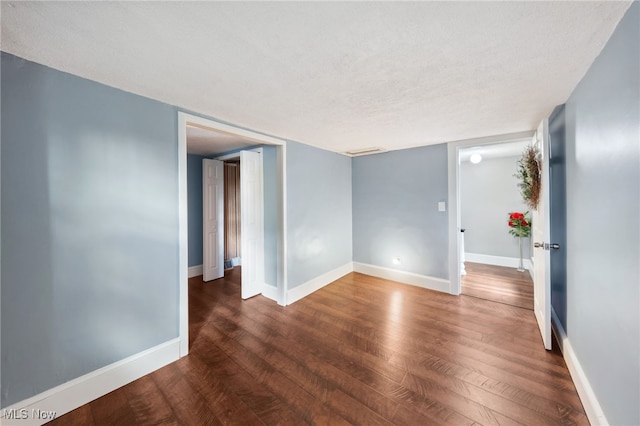 6813 W Clinton Ave, Cleveland, OH 44102 - unfurnished room with wood finished floors, a textured ceiling, and baseboards