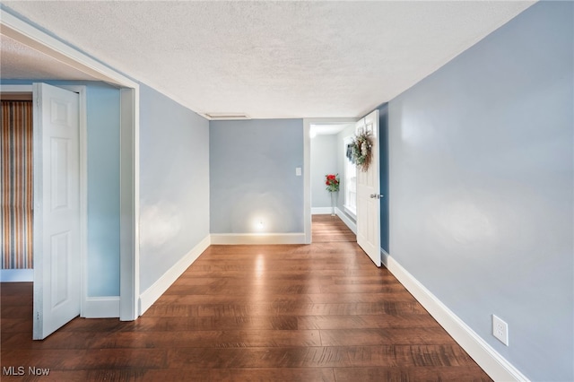6813 W Clinton Ave, Cleveland, OH 44102 - empty room with wood finished floors, a textured ceiling, and baseboards
