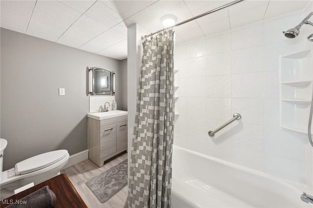 6813 W Clinton Ave, Cleveland, OH 44102 - bathroom with shower / bath combination with curtain, vanity, wood finished floors, toilet, and backsplash