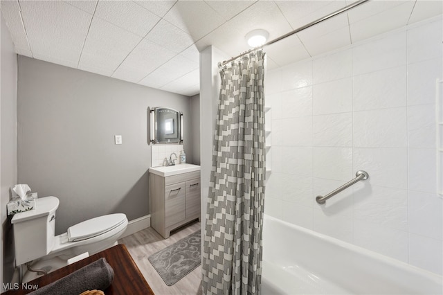 6813 W Clinton Ave, Cleveland, OH 44102 - full bathroom with toilet, wood finished floors, vanity, and shower / bath combo with shower curtain