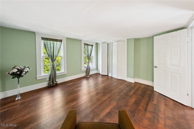 6813 W Clinton Ave, Cleveland, OH 44102 - unfurnished bedroom featuring dark wood-type flooring and baseboards
