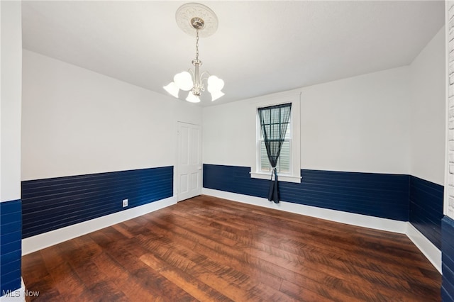 6813 W Clinton Ave, Cleveland, OH 44102 - empty room with a chandelier, wood finished floors, and baseboards