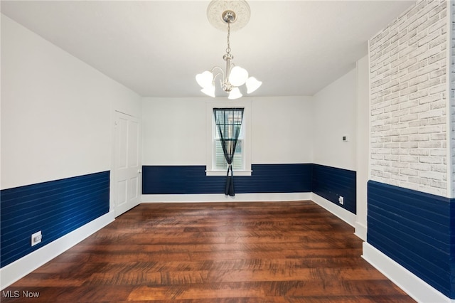 6813 W Clinton Ave, Cleveland, OH 44102 - empty room with a chandelier, wood finished floors, and baseboards