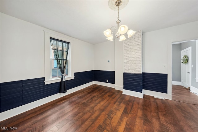 6813 W Clinton Ave, Cleveland, OH 44102 - empty room featuring a chandelier, wood finished floors, and baseboards