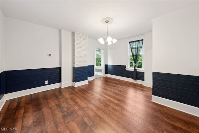 6813 W Clinton Ave, Cleveland, OH 44102 - unfurnished room featuring wood finished floors, baseboards, a chandelier, and a fireplace