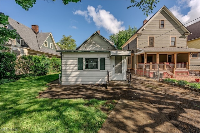 6813 W Clinton Ave, Cleveland, OH 44102 - view of front facade with a front yard, a chimney, a deck, and entry steps