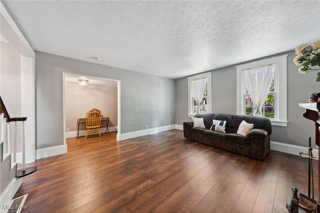 6813 W Clinton Ave, Cleveland, OH 44102 - living area featuring dark wood-style flooring, a textured ceiling, and baseboards