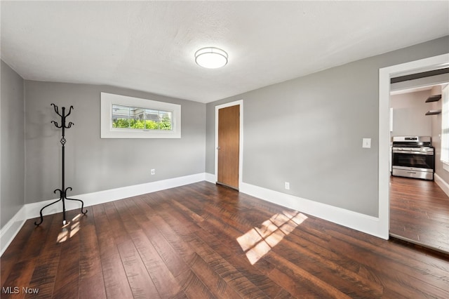 6813 W Clinton Ave, Cleveland, OH 44102 - unfurnished bedroom with dark wood-style flooring and baseboards