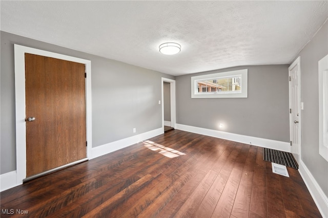 6813 W Clinton Ave, Cleveland, OH 44102 - spare room with a textured ceiling, wood-type flooring, and baseboards