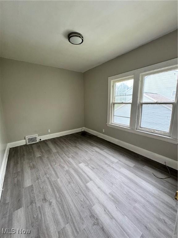 3293 E 121st St, Cleveland, OH 44120 - spare room featuring baseboards and wood finished floors