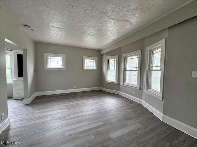 3293 E 121st St, Cleveland, OH 44120 - empty room with a textured ceiling, dark wood-style flooring, and baseboards