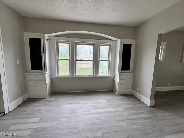 3293 E 121st St, Cleveland, OH 44120 - unfurnished bedroom featuring wood finished floors, a textured ceiling, and baseboards
