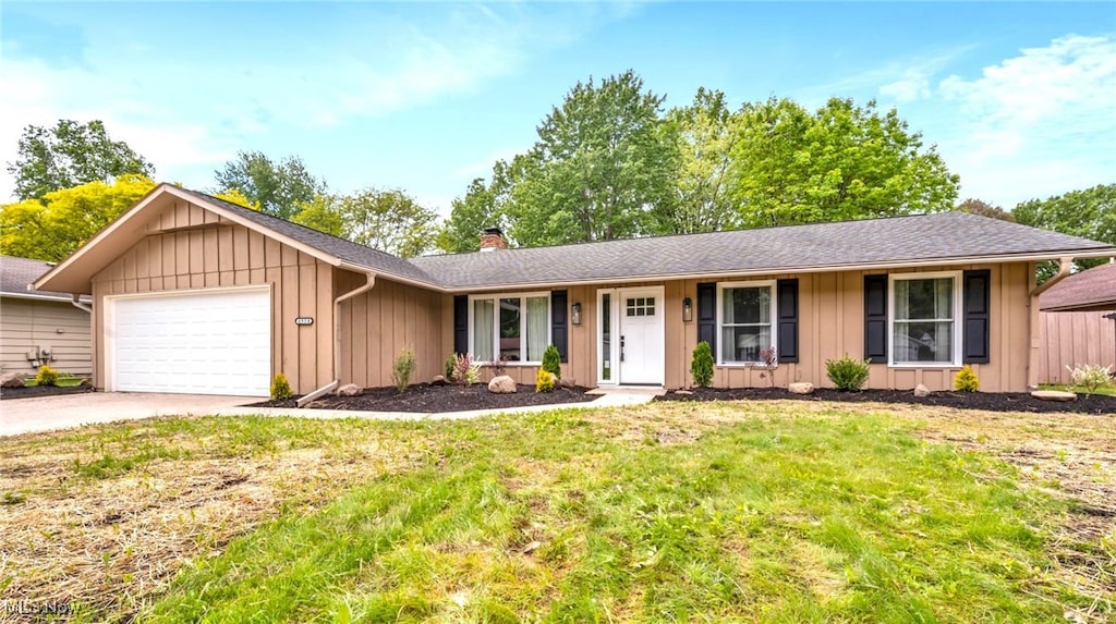 4950 Meadow Moss Ln, North Ridgeville, OH 44039 - ranch-style house with a garage, board and batten siding, driveway, a chimney, and a front yard