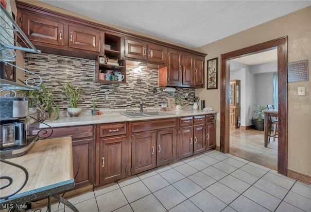 4521 W 147th St, Cleveland, OH 44135 - kitchen featuring a sink, tasteful backsplash, open shelves, light tile patterned floors, and baseboards