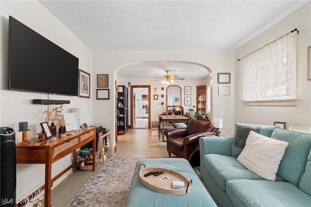794 Ranney St, Akron, OH 44310 - living room with arched walkways, a textured ceiling, and a ceiling fan