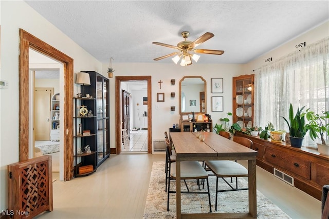 794 Ranney St, Akron, OH 44310 - dining room with ceiling fan, arched walkways, and a textured ceiling