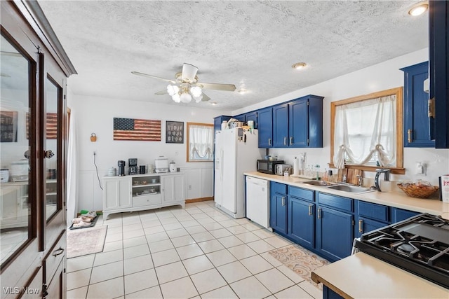 794 Ranney St, Akron, OH 44310 - kitchen featuring blue cabinetry, white appliances, light countertops, a ceiling fan, and plenty of natural light