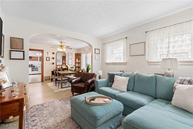 794 Ranney St, Akron, OH 44310 - living area featuring arched walkways, a ceiling fan, a textured ceiling, and wood finished floors