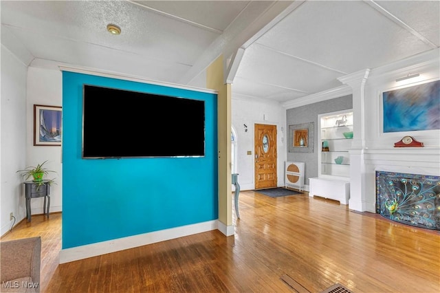 1837 E Erie Ave, Lorain, OH 44052 - unfurnished living room featuring wood finished floors, built in features, and baseboards