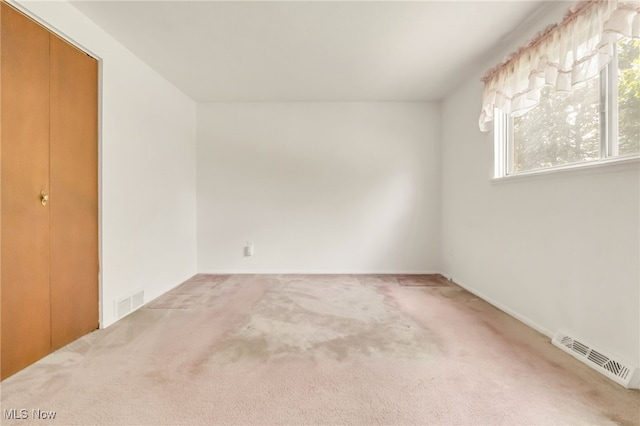36948 S Lake Shore Blvd, Eastlake, OH 44095 - unfurnished bedroom featuring multiple windows, carpet flooring, and a closet