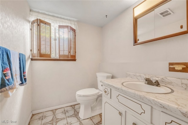 36948 S Lake Shore Blvd, Eastlake, OH 44095 - bathroom with vanity, toilet, baseboards, and tile patterned floors