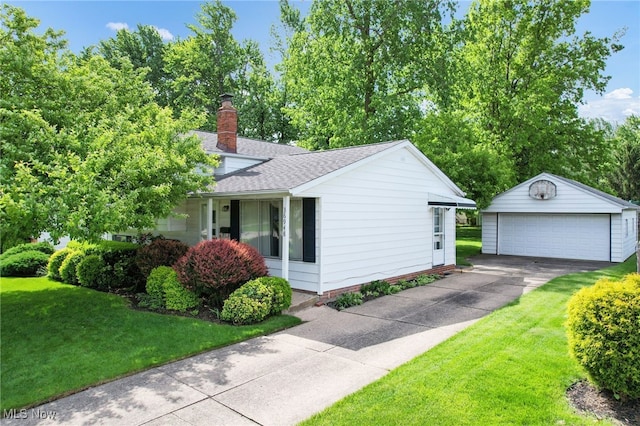 36948 S Lake Shore Blvd, Eastlake, OH 44095 - view of property exterior featuring an outbuilding, a detached garage, a yard, roof with shingles, and a chimney