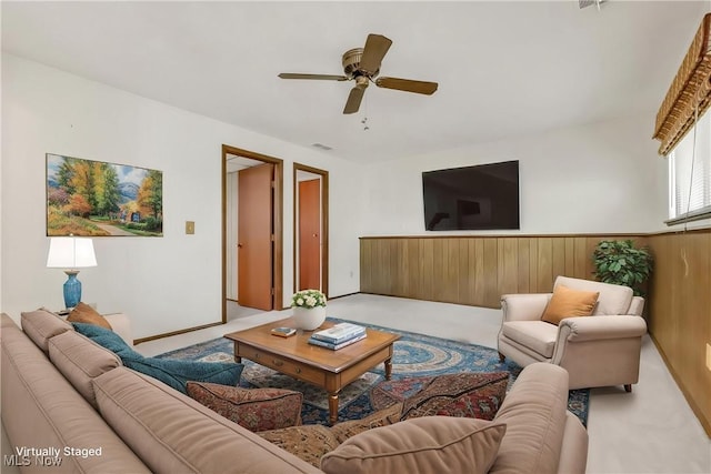36948 S Lake Shore Blvd, Eastlake, OH 44095 - living area with carpet flooring, a ceiling fan, wooden walls, and wainscoting