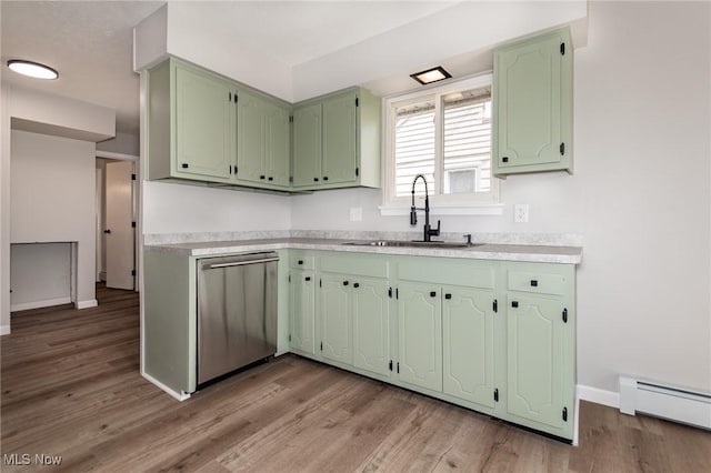 1294 E 345th St, Eastlake, OH 44095 - kitchen featuring dishwasher, a baseboard radiator, a sink, baseboards, and green cabinetry