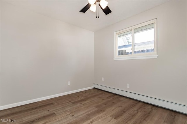 1294 E 345th St, Eastlake, OH 44095 - empty room with baseboard heating, wood finished floors, a ceiling fan, and baseboards