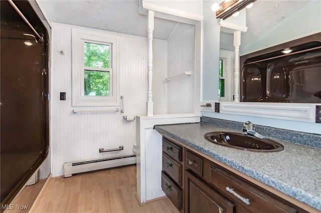 36981 Chardon Rd, Willoughby Hills, OH 44094 - bathroom with a baseboard radiator, wood finished floors, vanity, toilet, and a shower