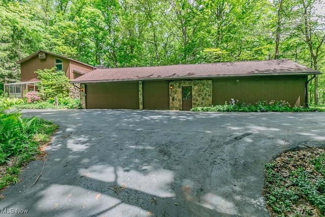 36981 Chardon Rd, Willoughby Hills, OH 44094 - view of front of property with stone siding, asphalt driveway, and an attached garage