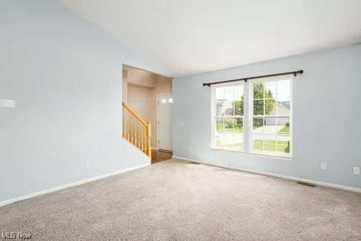 734 Sparrow Way, Wadsworth, OH 44281 - carpeted spare room featuring stairs, lofted ceiling, and baseboards