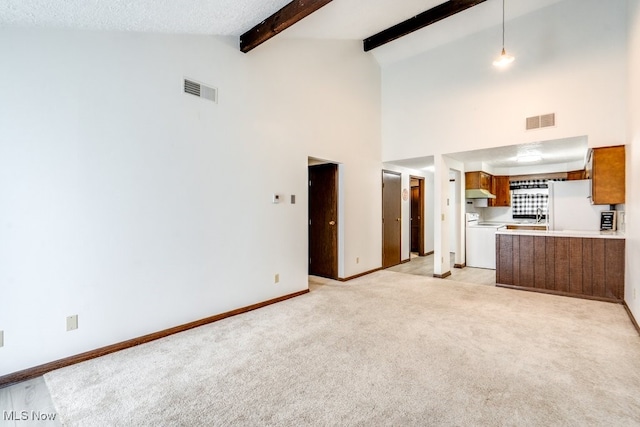 2377 Ansley St, Alliance, OH 44601 - unfurnished living room featuring light colored carpet, high vaulted ceiling, beam ceiling, and baseboards