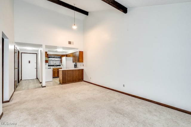 2377 Ansley St, Alliance, OH 44601 - unfurnished living room featuring light colored carpet, beamed ceiling, baseboards, and high vaulted ceiling