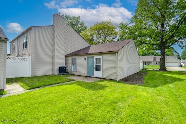 2377 Ansley St, Alliance, OH 44601 - rear view of house featuring cooling unit, a patio area, a chimney, and a shingled roof