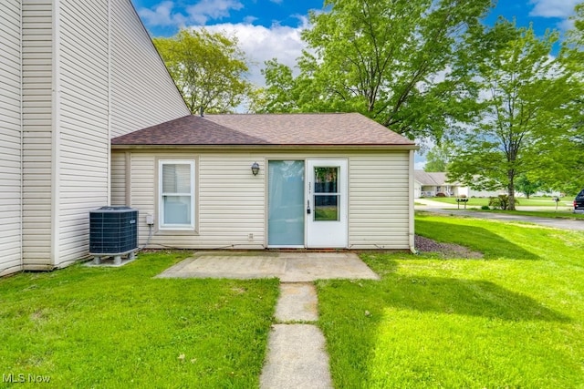 2377 Ansley St, Alliance, OH 44601 - view of front of property featuring cooling unit, a front yard, a patio, and roof with shingles