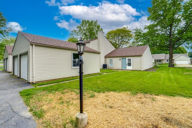 2377 Ansley St, Alliance, OH 44601 - back of property featuring central AC and a lawn