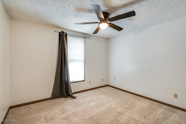 2377 Ansley St, Alliance, OH 44601 - spare room with light colored carpet, a ceiling fan, a textured ceiling, and baseboards