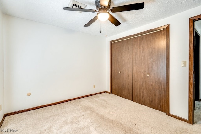 2377 Ansley St, Alliance, OH 44601 - unfurnished bedroom featuring carpet, a closet, baseboards, and a textured ceiling