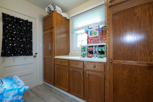 5940 Hansom Dr, Solon, OH 44139 - kitchen with brown cabinets, light wood finished floors, and light countertops