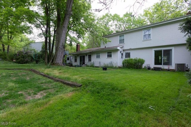 5940 Hansom Dr, Solon, OH 44139 - rear view of house with a chimney and a lawn