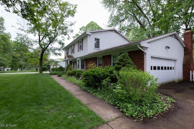5940 Hansom Dr, Solon, OH 44139 - view of property exterior with a garage, asphalt driveway, a lawn, and brick siding