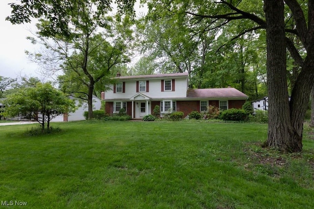 5940 Hansom Dr, Solon, OH 44139 - view of front of house featuring a front lawn, a chimney, and brick siding