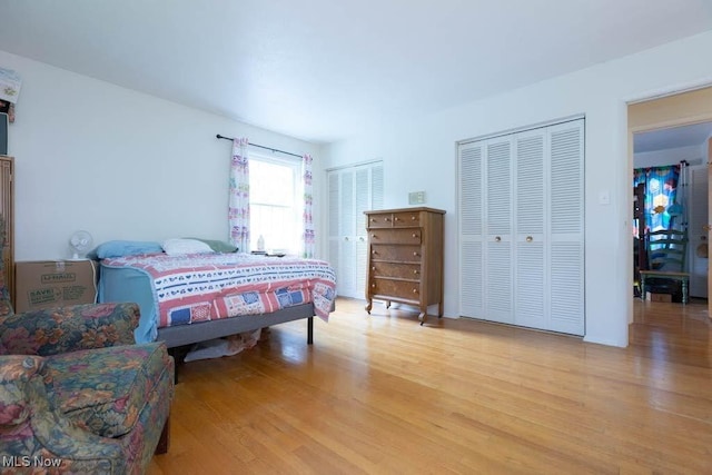 5940 Hansom Dr, Solon, OH 44139 - bedroom featuring light wood finished floors and two closets