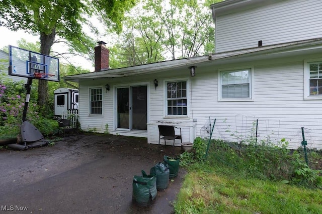5940 Hansom Dr, Solon, OH 44139 - back of house featuring a chimney and a patio